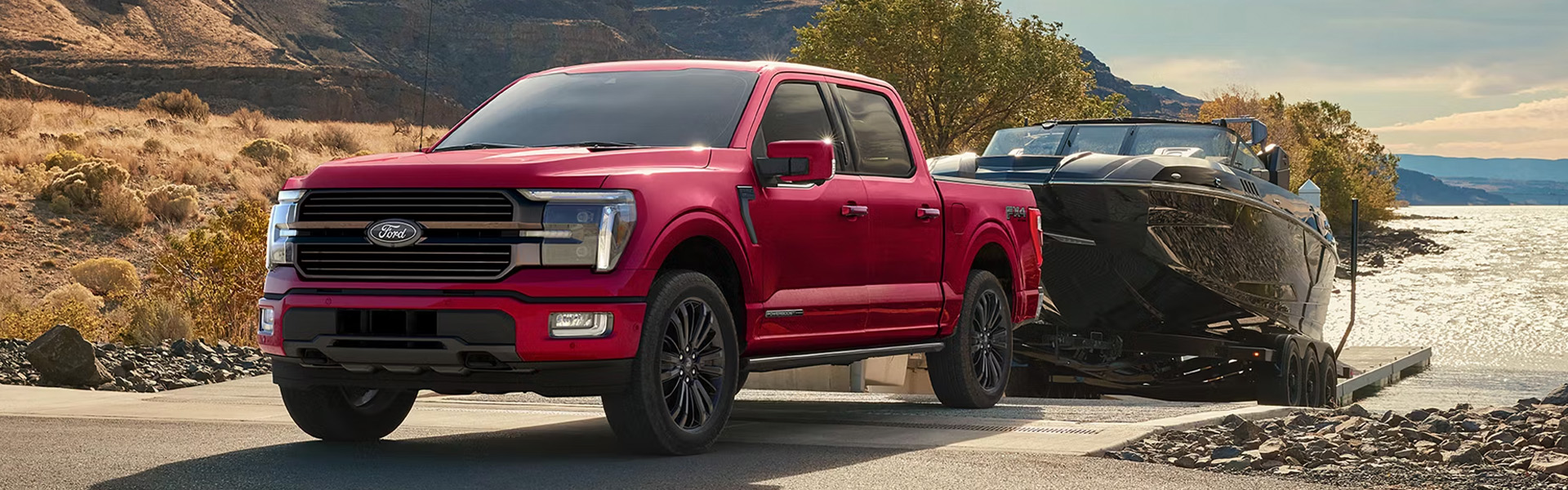 Red Ford F-150 towing a boat near the water